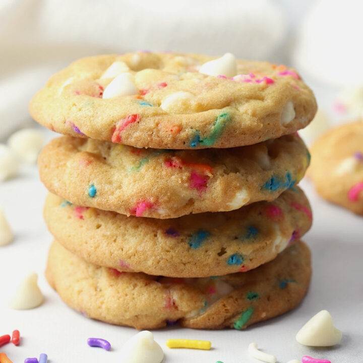 A stack of cookies with rainbow sprinkles.