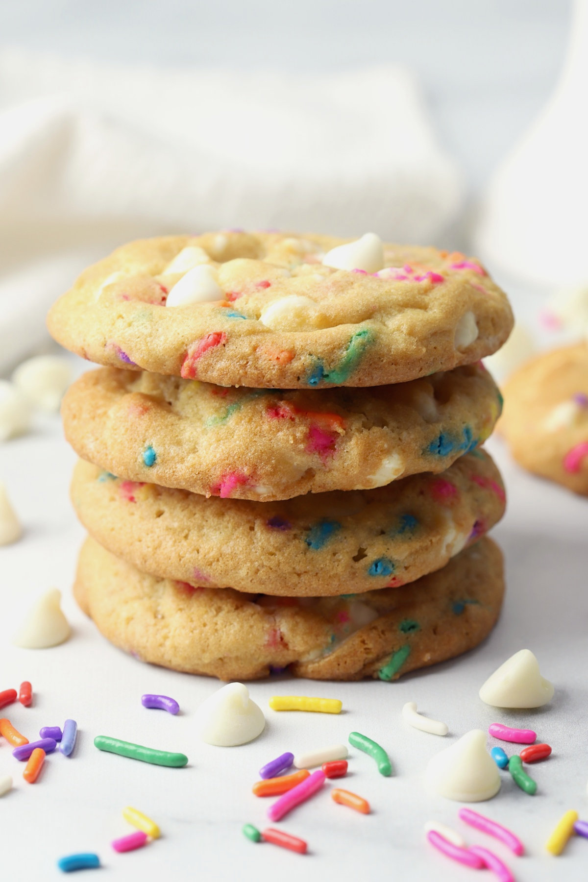 A stack of cookies with rainbow sprinkles.