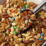 Metal scoop in a bowl of trail mix.