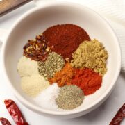 A bowl filled with various spices.