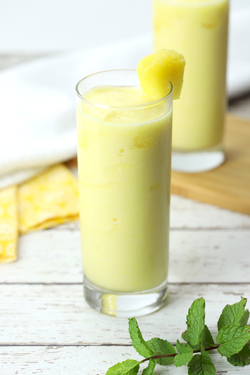 Pineapple drink with a pineapple wedge on the glass.