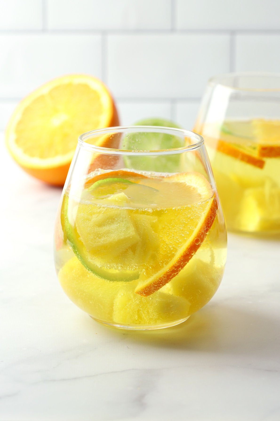 A wine glass filled with white wine sangria.