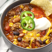 Bowl of taco chili topped with jalapeno slices.