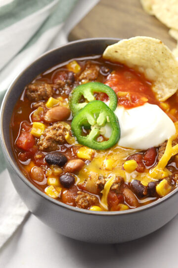 Bowl of taco chili topped with jalapeno slices.
