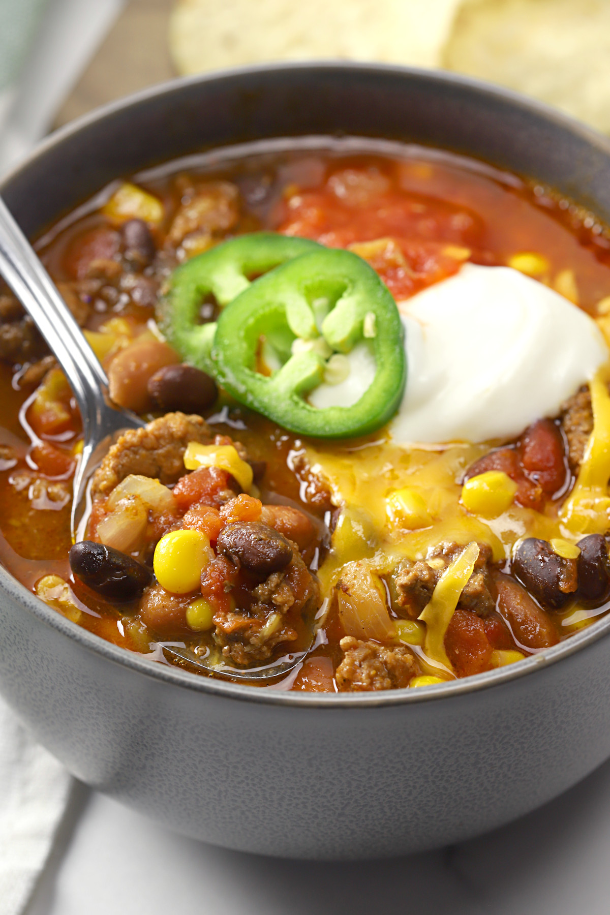 Metal spoon in a bowl of chili.