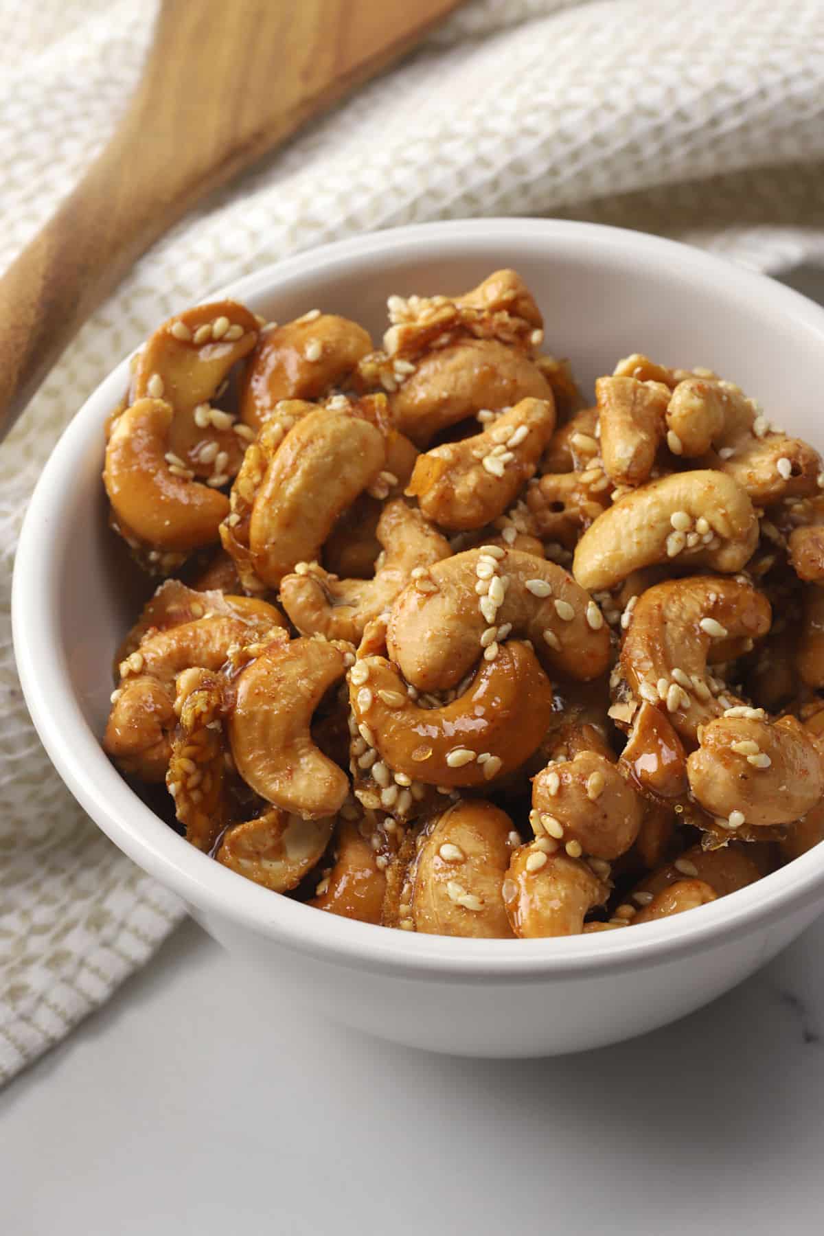 A small bowl filled with honey sesame cashews.