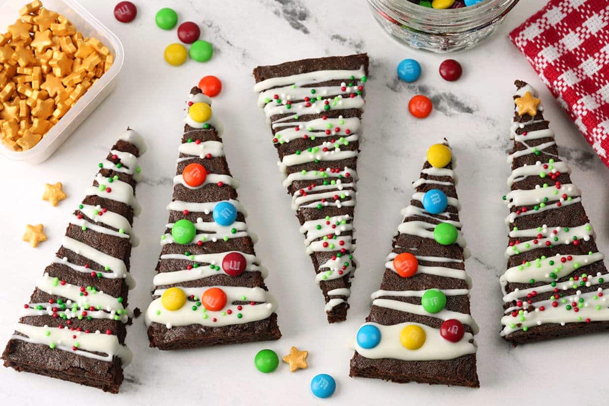 Christmas tree brownies lined up on a counter top.