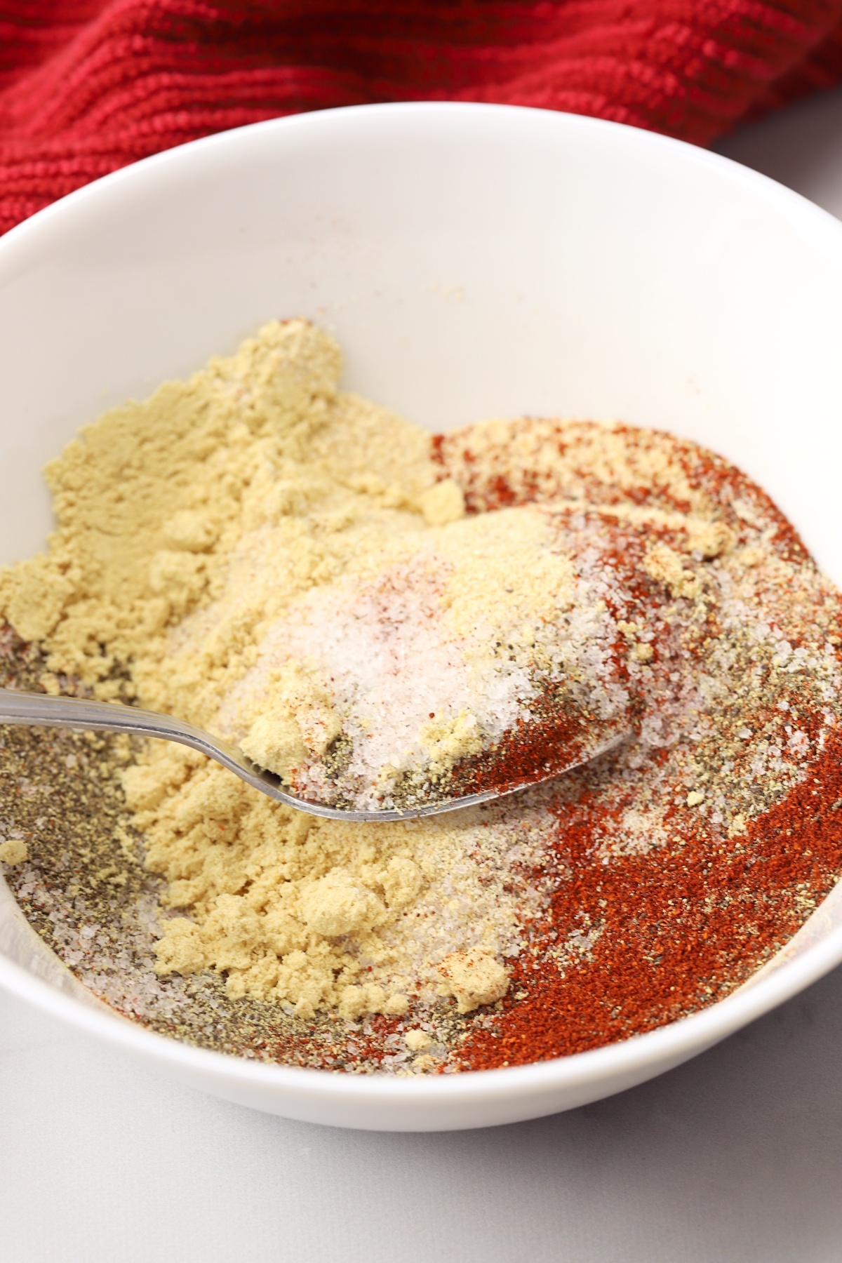 Mixing spices with a metal spoon.