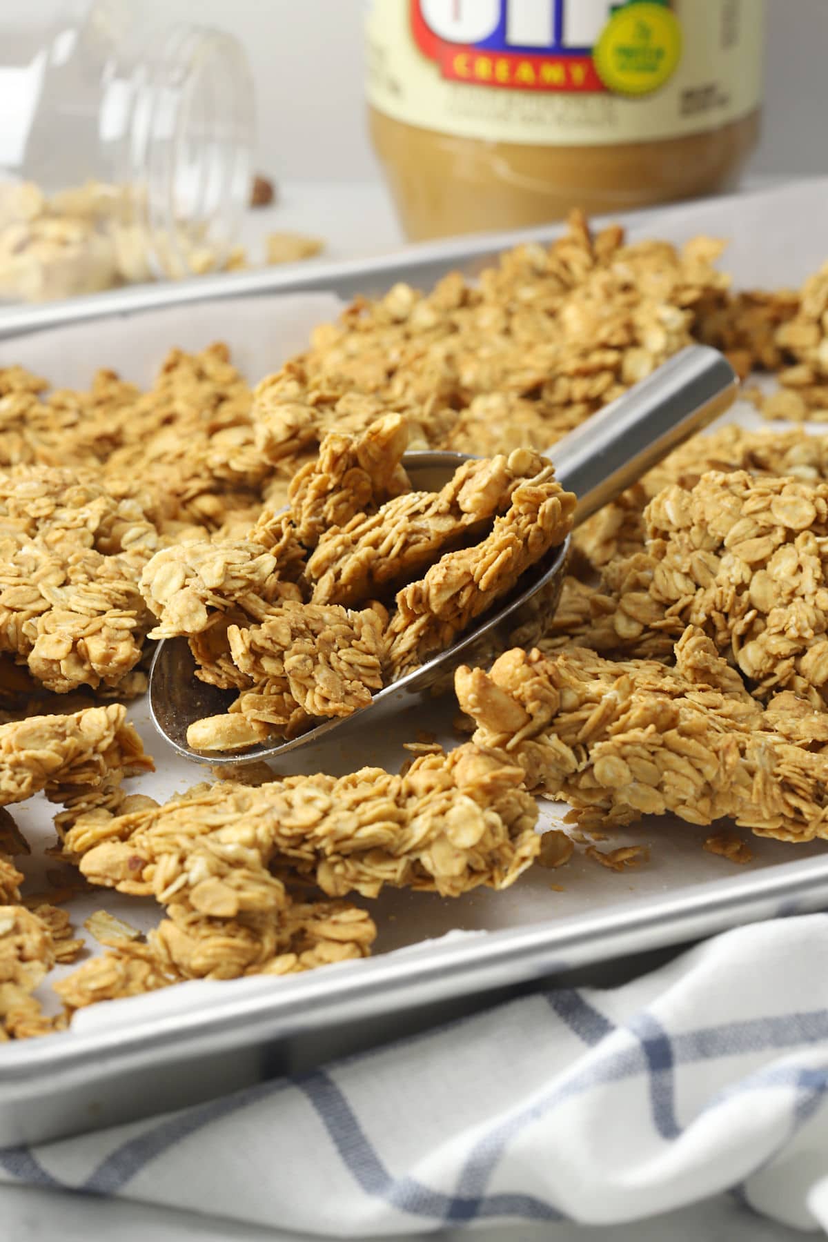 Metal scoop filled with peanut butter granola.