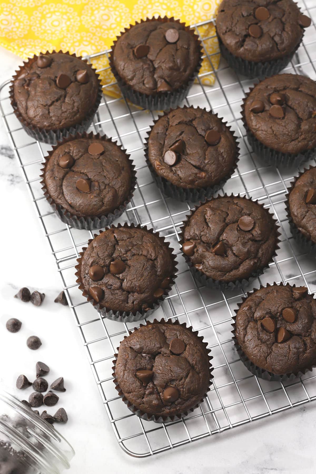 Chocolate muffins on a metal cooling rack.