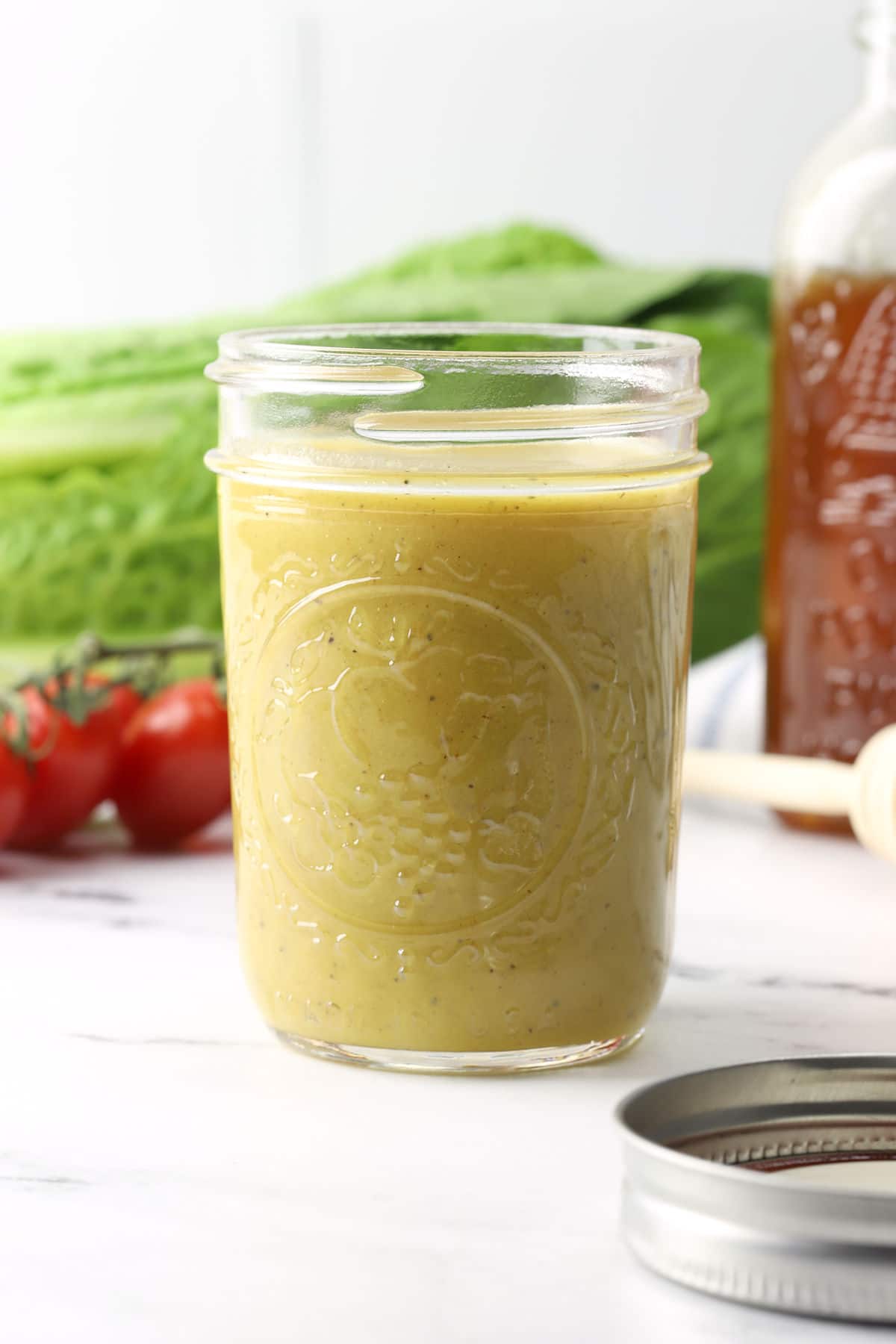 Mason jar filled with honey mustard dressing.