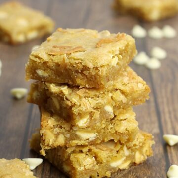A stack of blondies on a wood counter top.