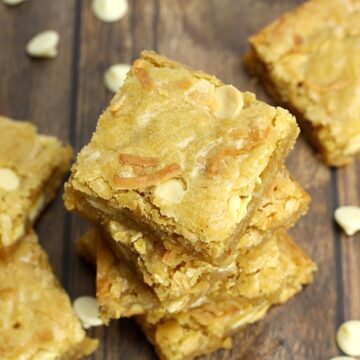 A stack of blondies with toasted coconut on top.