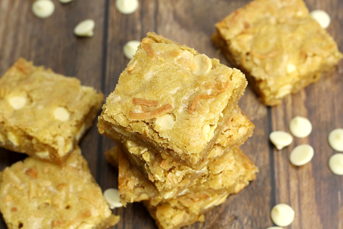 A stack of blondies with toasted coconut on top.
