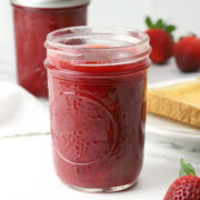 Strawberry jam in a glass jar.