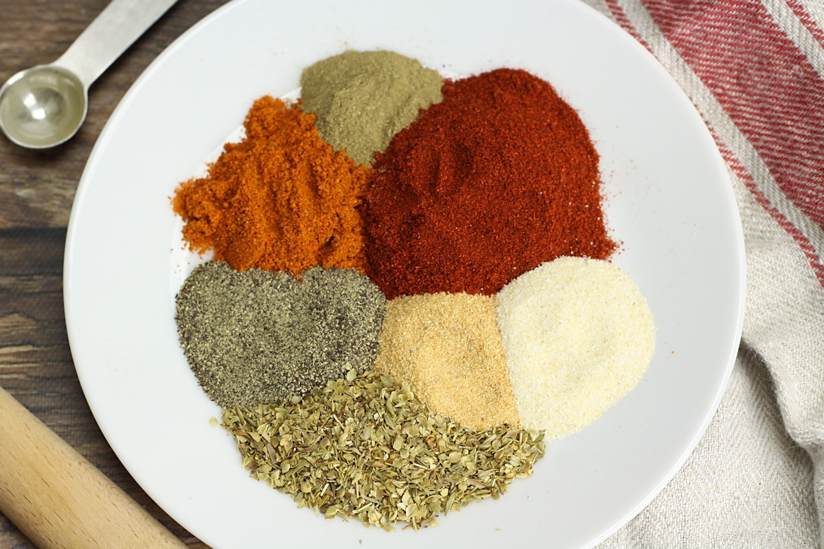 A white plate filled with spices.