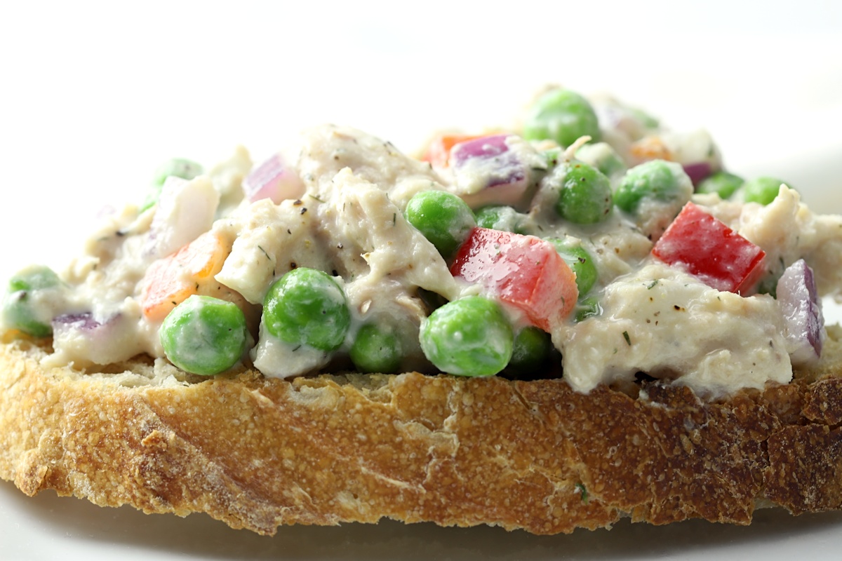 Sweet peas, red onion, and bell pepper in a tuna salad.