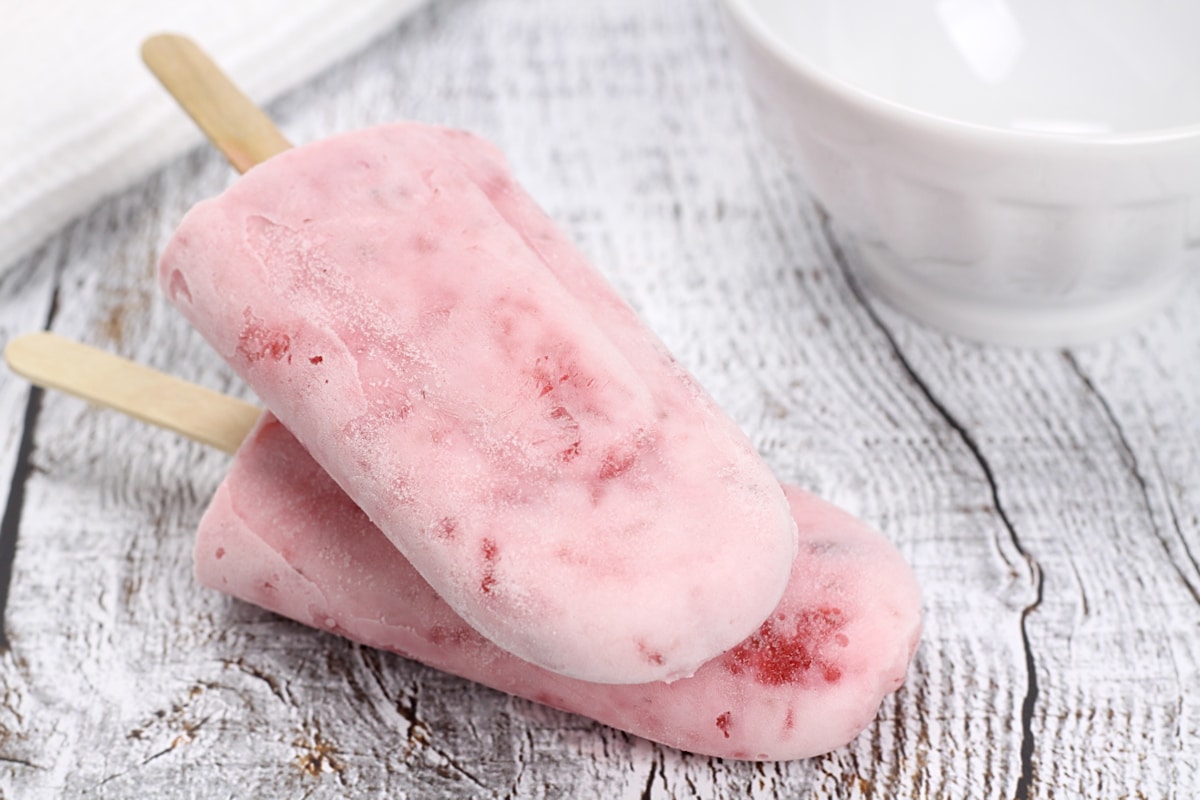 Two strawberry popsicles stacked on top of each other.