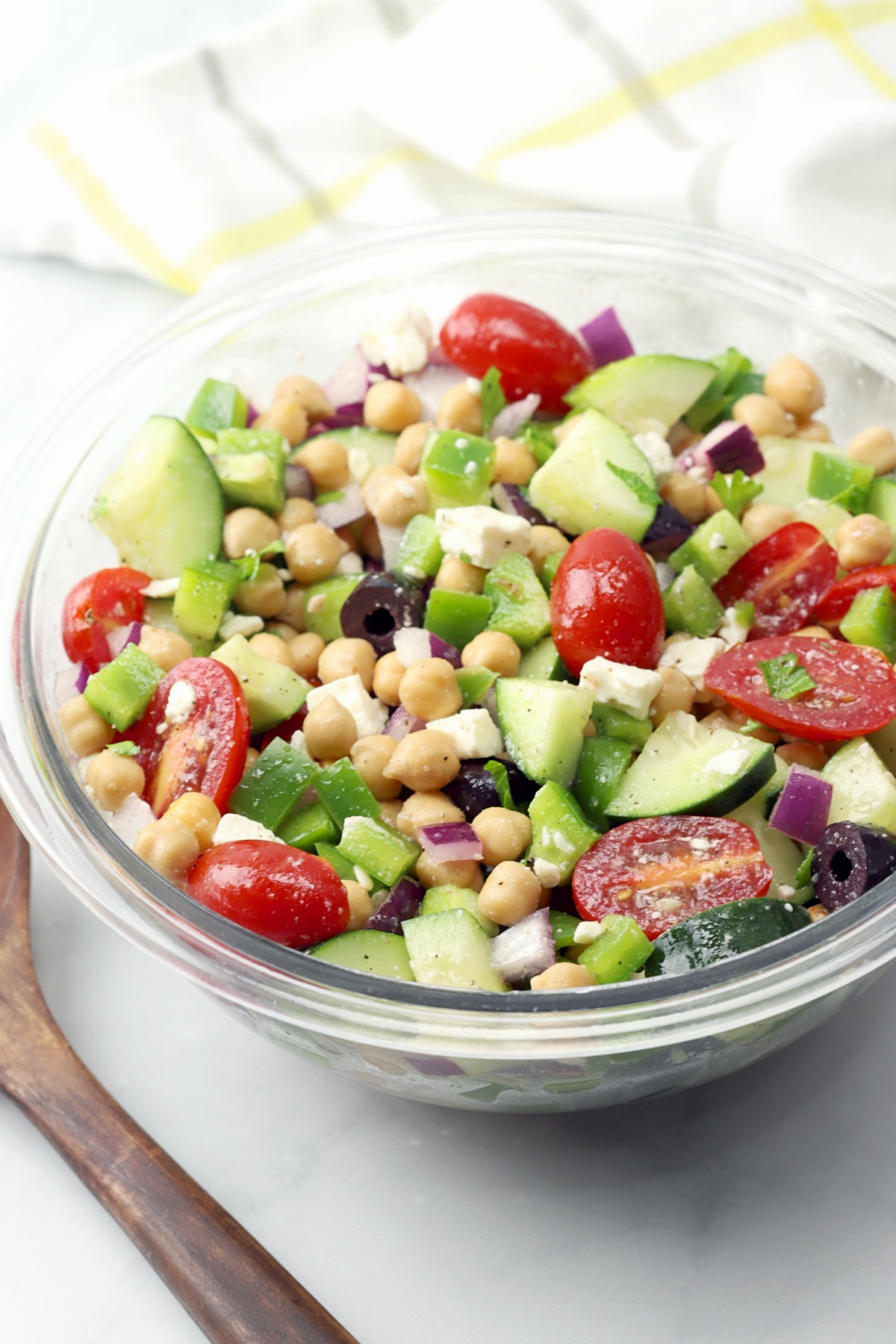 Chickpea salad with cucumbers, olives, and tomatoes.