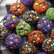 Cooling rack filled with decorated Halloween cookies.