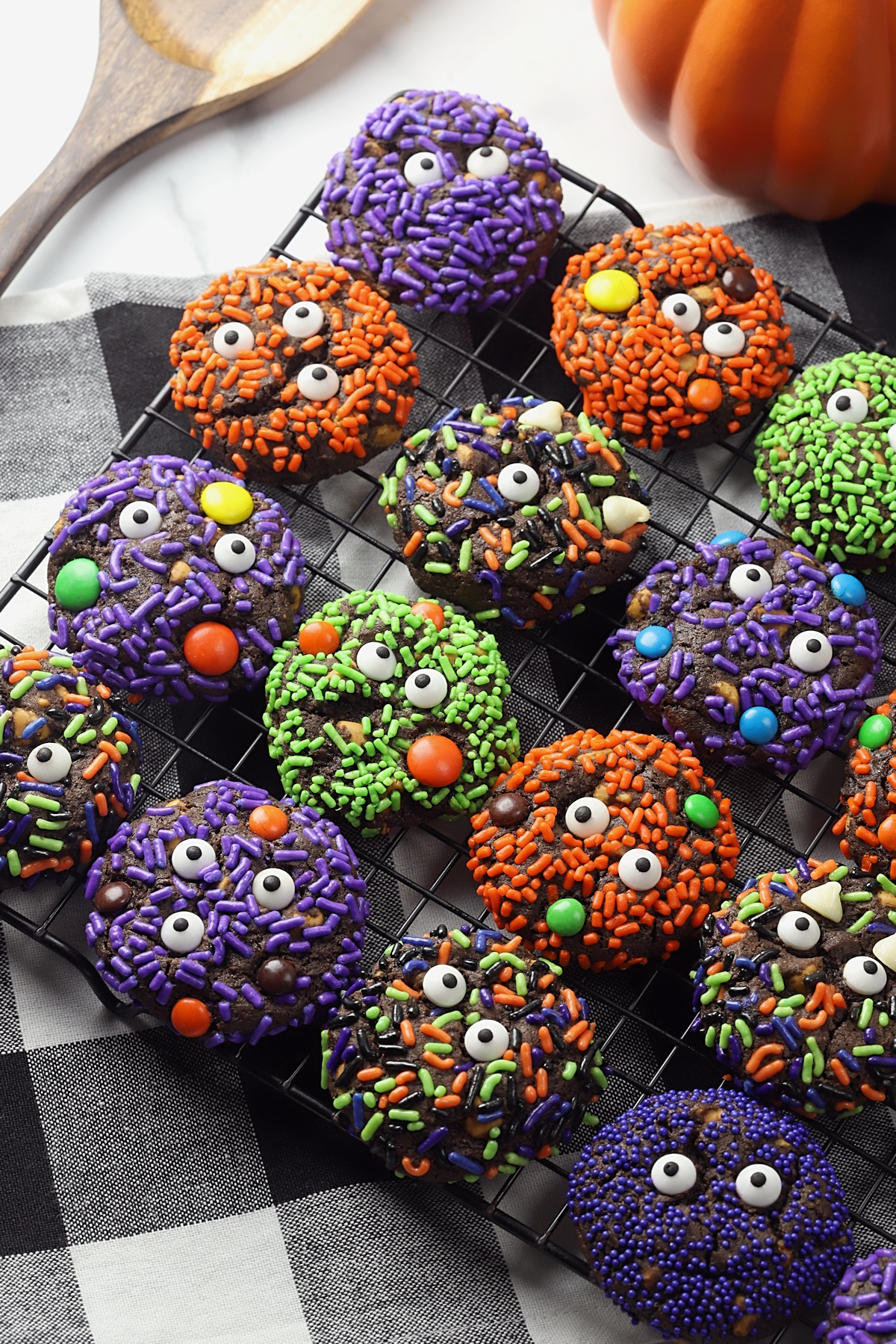 Cooling rack filled with decorated Halloween cookies.
