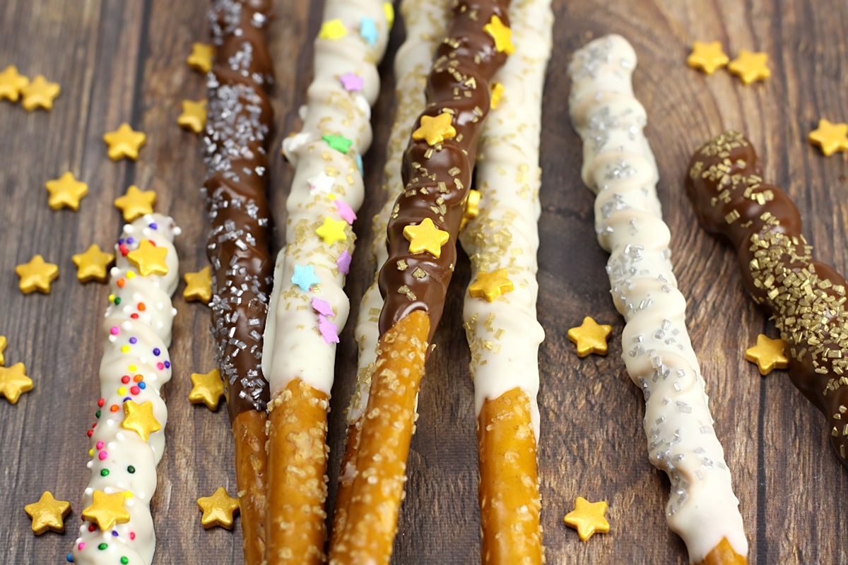 Pretzel rods dipped in chocolate with sprinkles.