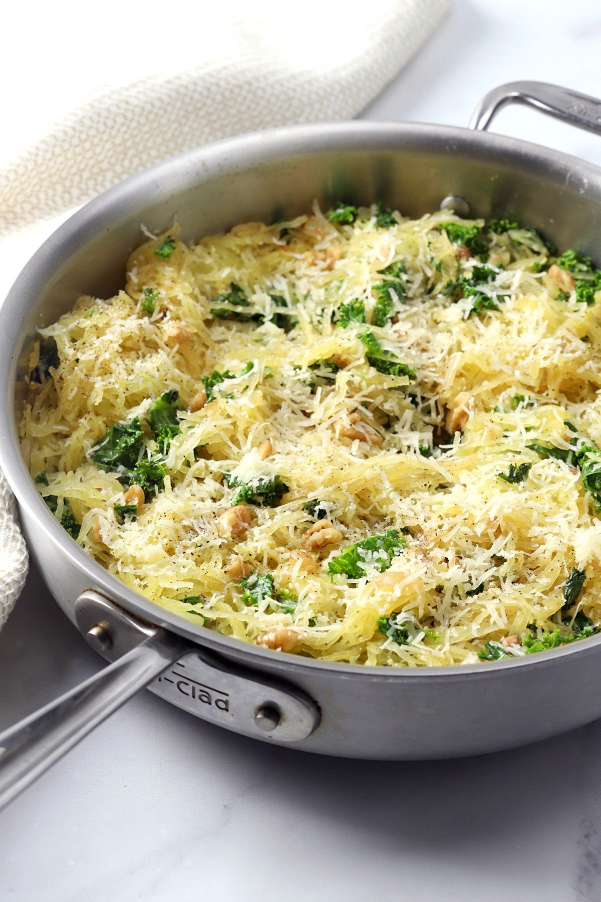 Parmesan cheese sprinkled on top of spaghetti squash in a pan.
