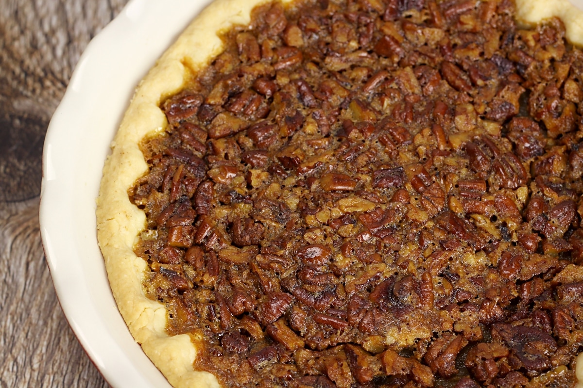 Chopped pecans forming a crust on top of pie.