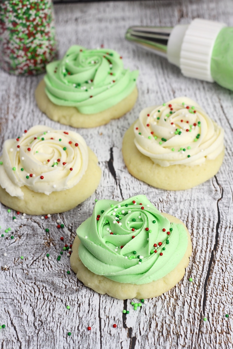 Cookies with white and green frosting on top.