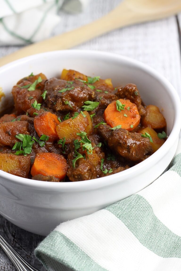 Parsley sprinkled on top of a bowl of beef stew.