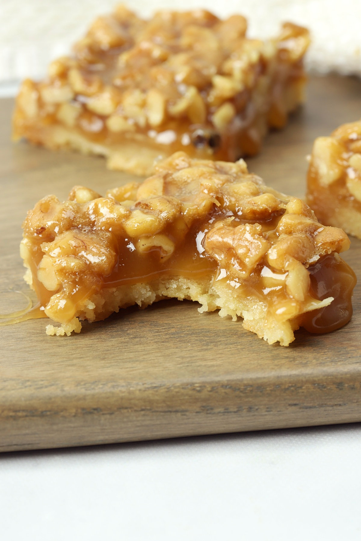 A bite taken from a honey walnut shortbread bar.