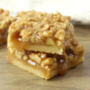 A stack of two shortbread bars topped with walnuts.