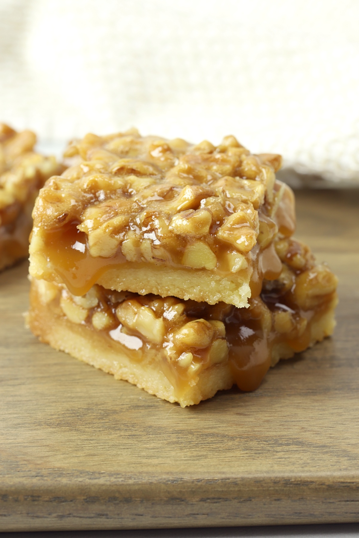 A stack of two shortbread bars topped with walnuts.