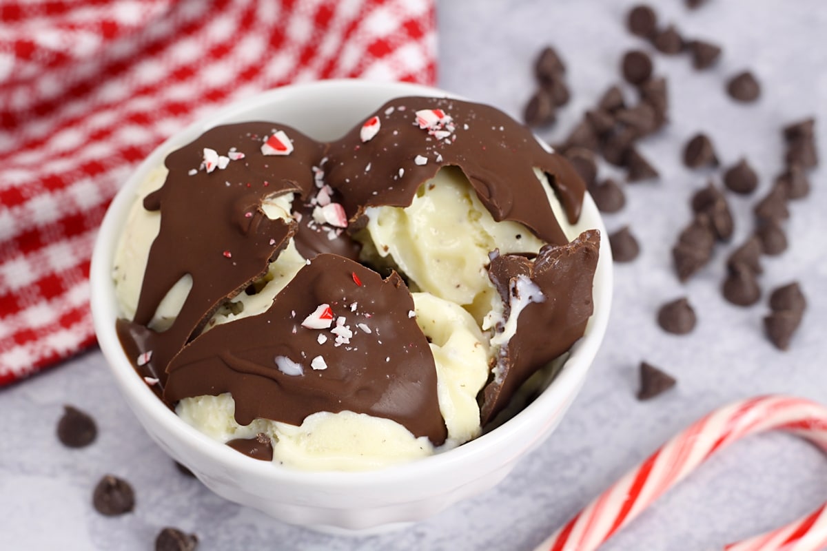 Chocolate shell cracked open to reveal vanilla ice cream underneath.