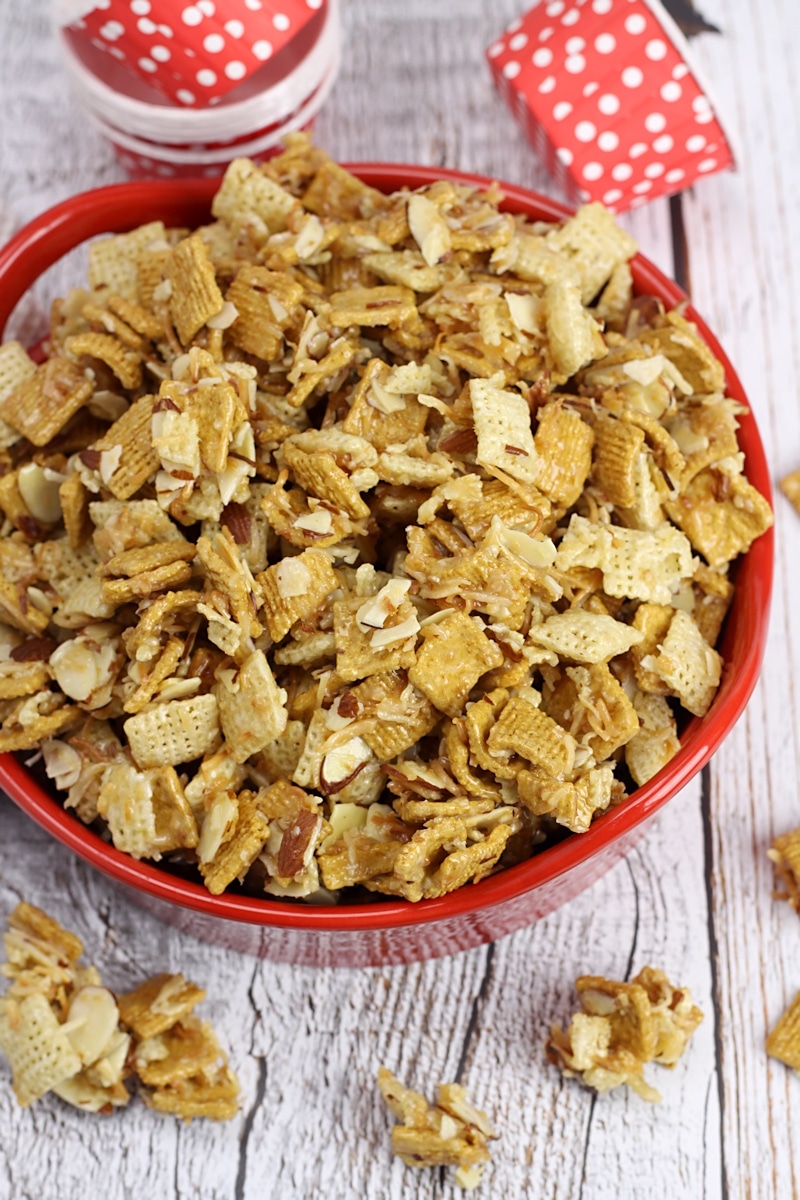 Golden grahams and chex coated in a sugar glaze in a red bowl.