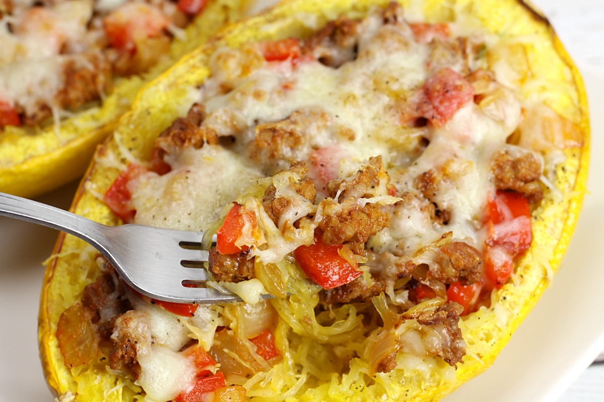 A fork digging into a cooked spaghetti squash.