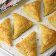 Ham and cheese puff pastry baked on a sheet pan.