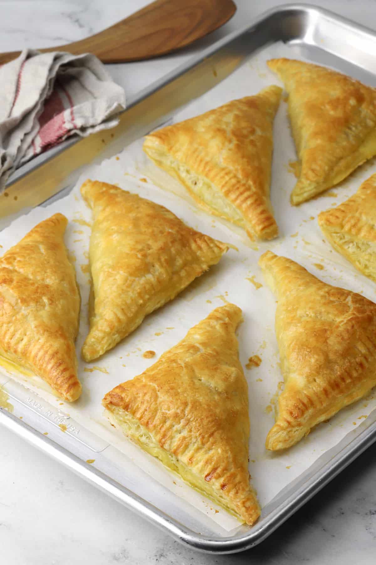 Ham and cheese puff pastry baked on a sheet pan.