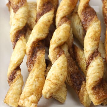 Close up of puff pastry twists on a plate.