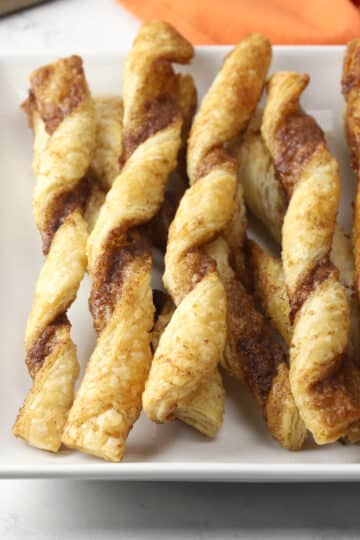 Close up of puff pastry twists on a plate.