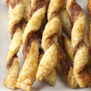 Close up of puff pastry twists on a plate.