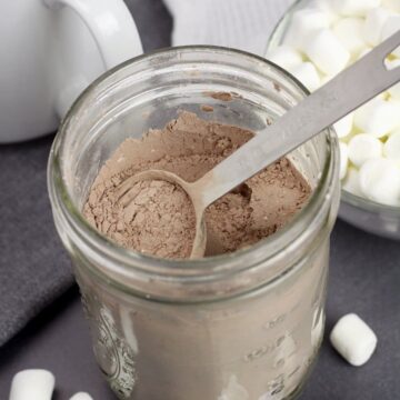 Mason jar filled with powdered hot chocolate mix.