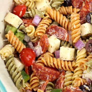 And overhead look at a bowl of classic pasta salad in an aqua bowl.