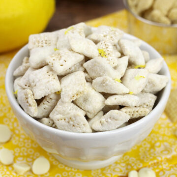 A decorative white bowl filled with lemon puppy chow.