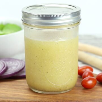 A mason jar filled with apple cider vinaigrette.