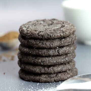 A stack of chocolate cookies on a grey counter top
