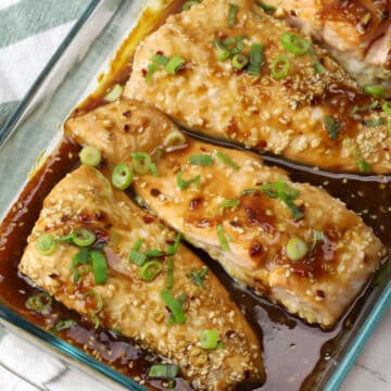 Baked teriyaki salmon in a glass casserole dish.