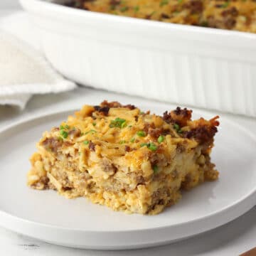 A slice of hash brown breakfast casserole on a serving plate.
