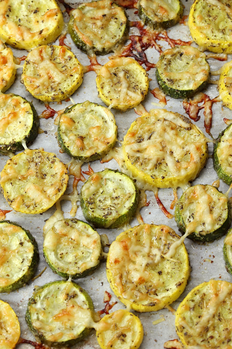 Zucchini and yellow squash discs sprinkled with parmesan cheese.