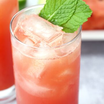 Close up of cocktail in a highball glass, with mint leaves